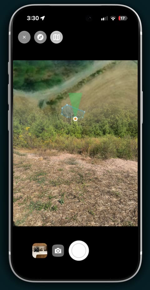 A phone camera viewfinder with a heading-up map overlaid.