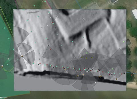 A hillshade layer over the project map, with photo view cones plotted on it.