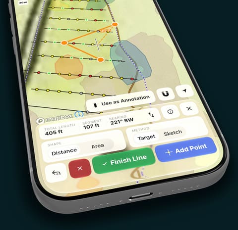 A phone measuring distance and bearing between points on the map.